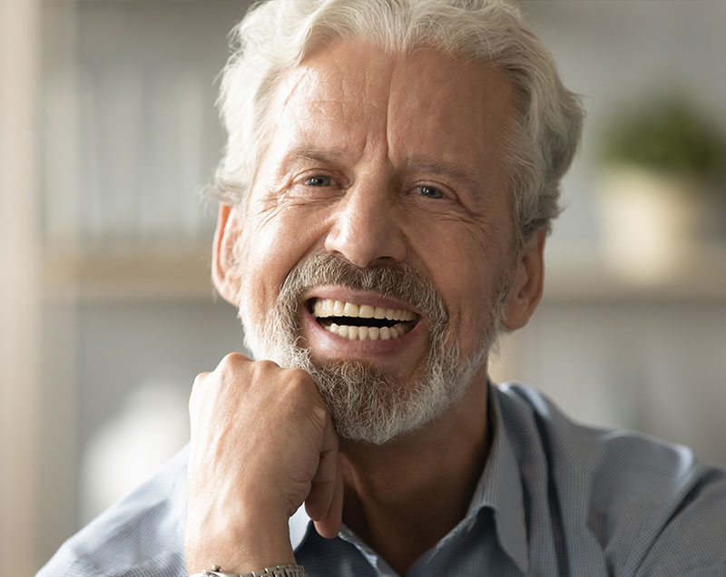older man with implanted dentures